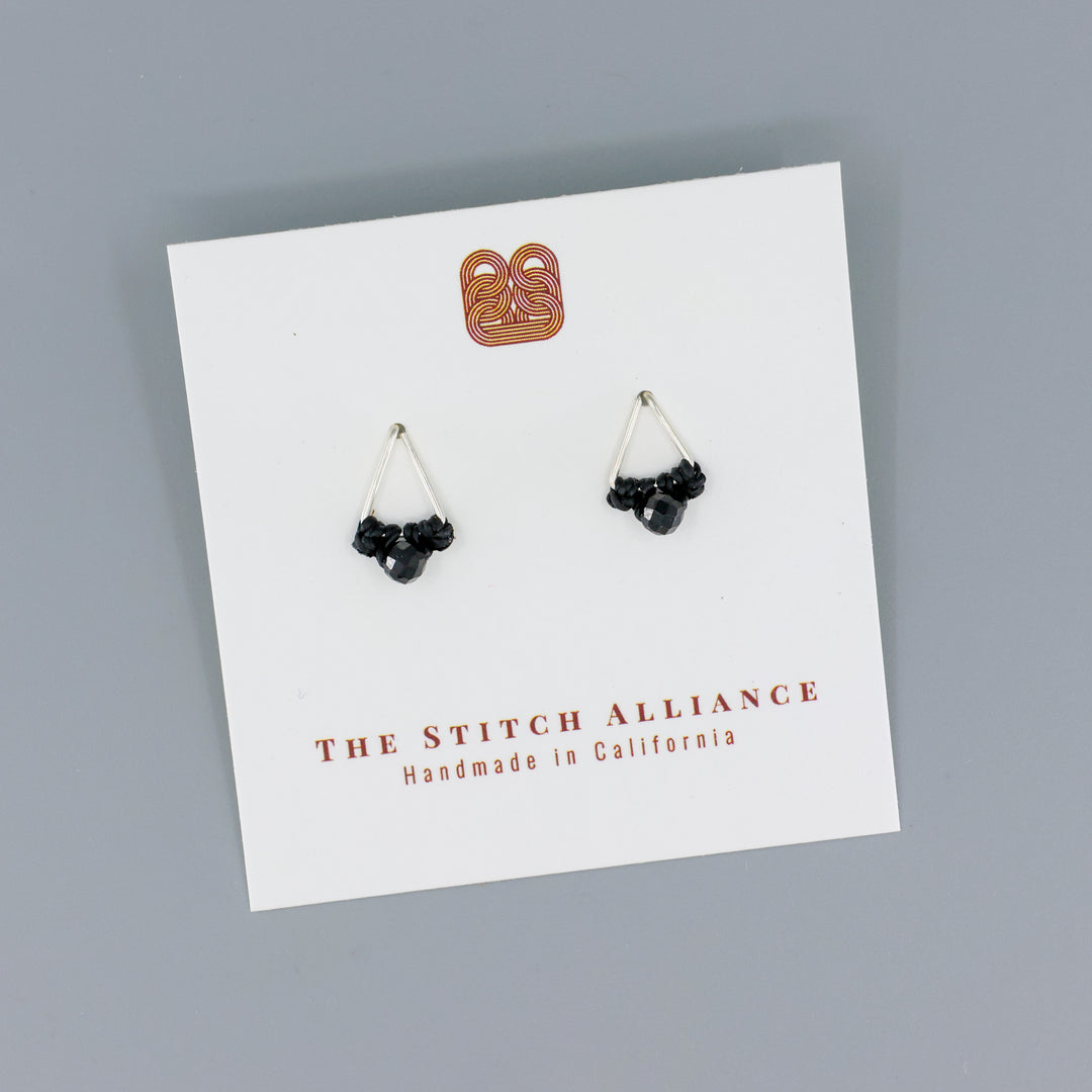 handmade triangle stud earrings sterling silver with black spinel beads on a gray background