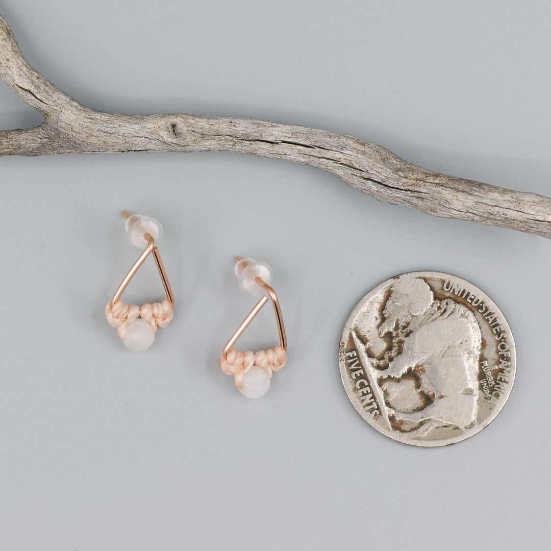 rose gold triangle earrings with moonstone bead with coin for size comparison