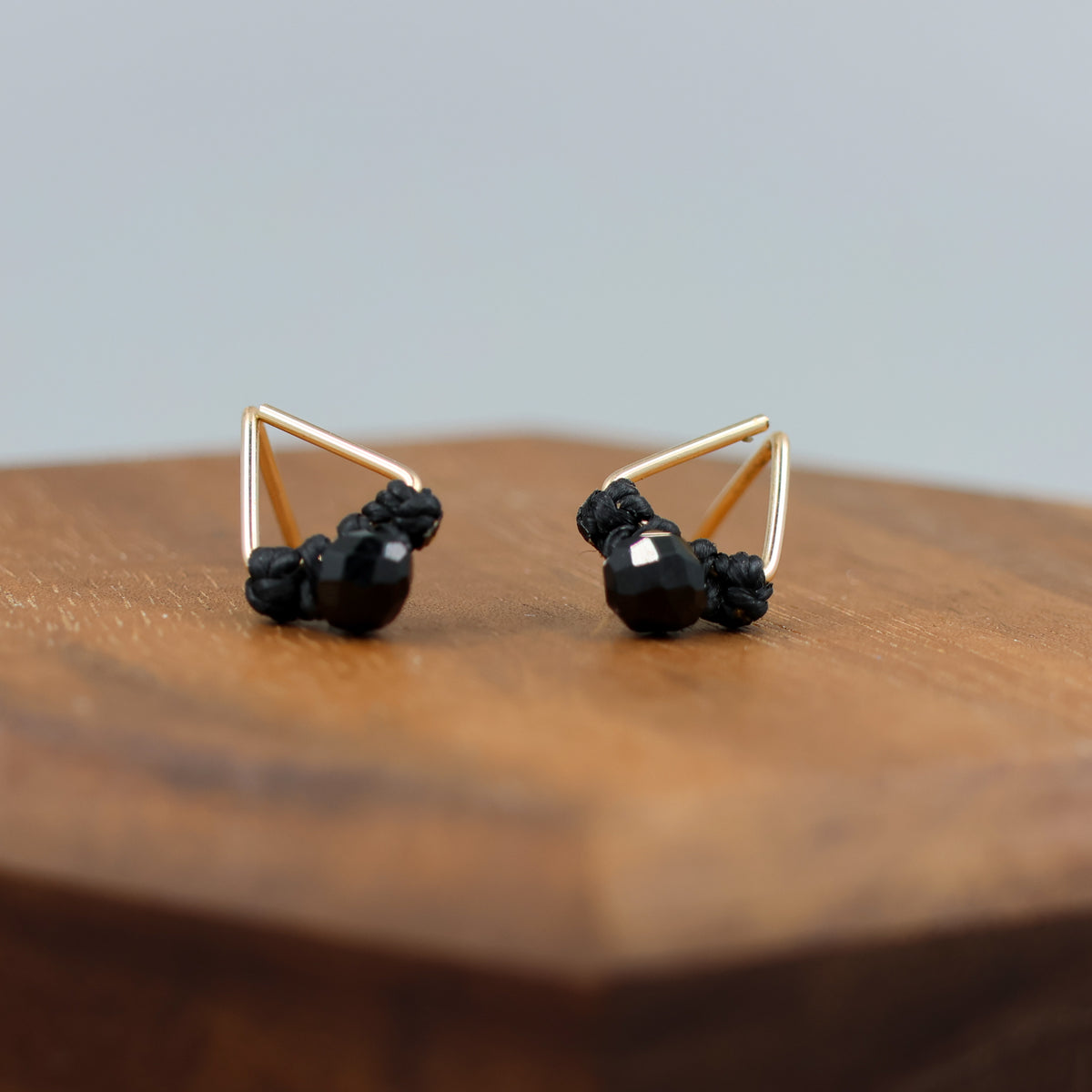 handmade triangle shaped earrings in gold fill with a black spinel bead