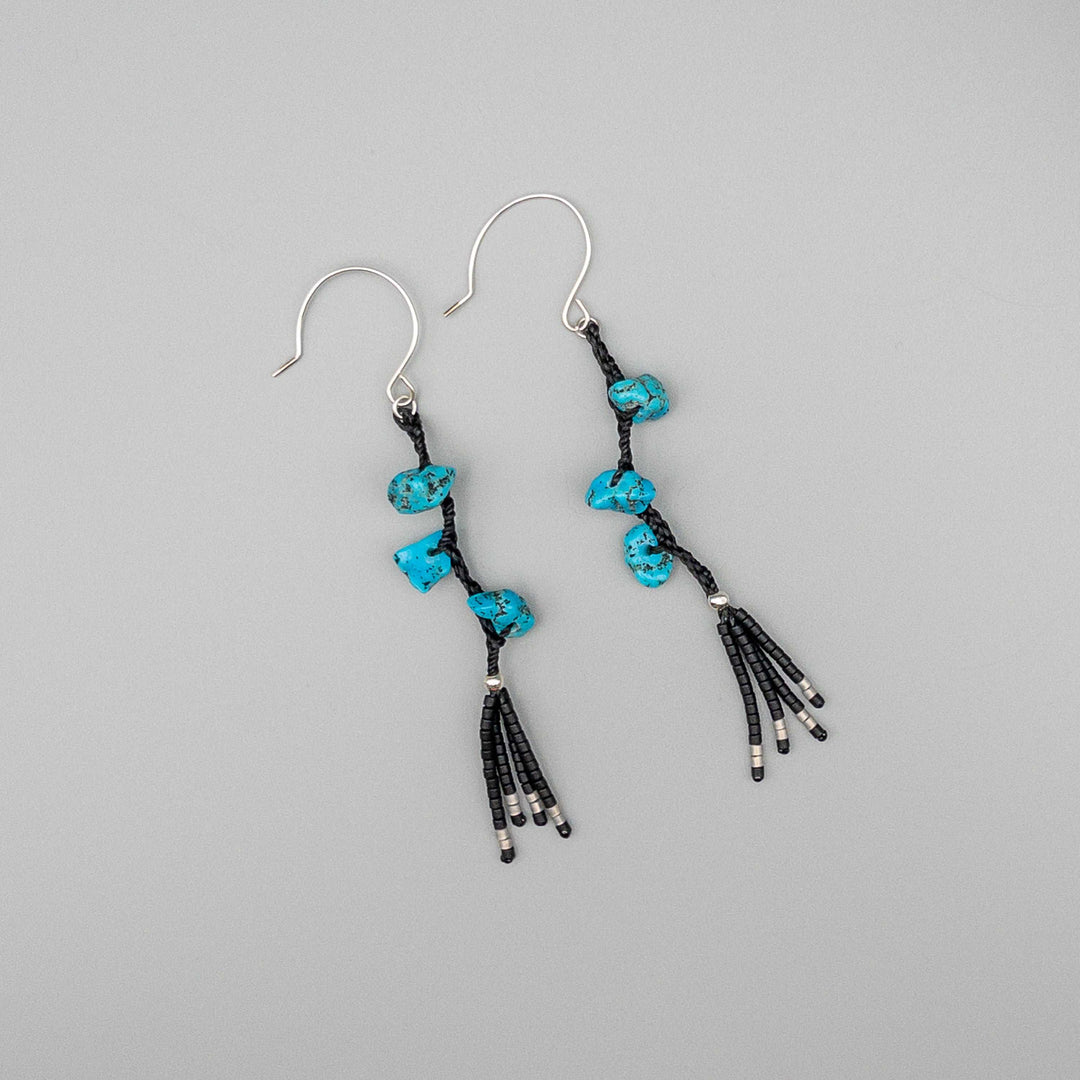 Western boho turquoise earrings sterling silver on a gray background