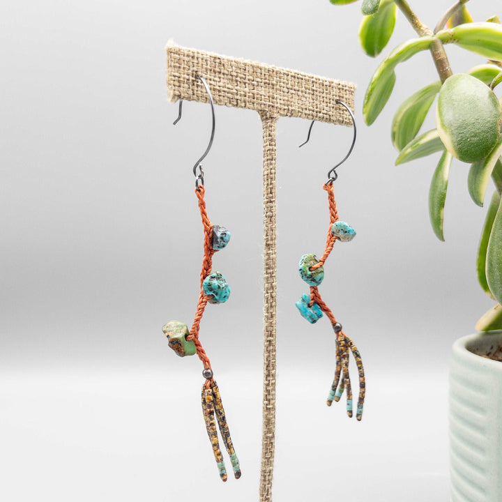 Turquoise dangle earrings with hand-formed oxidized sterling silver ear wires and a seed bead fringe.