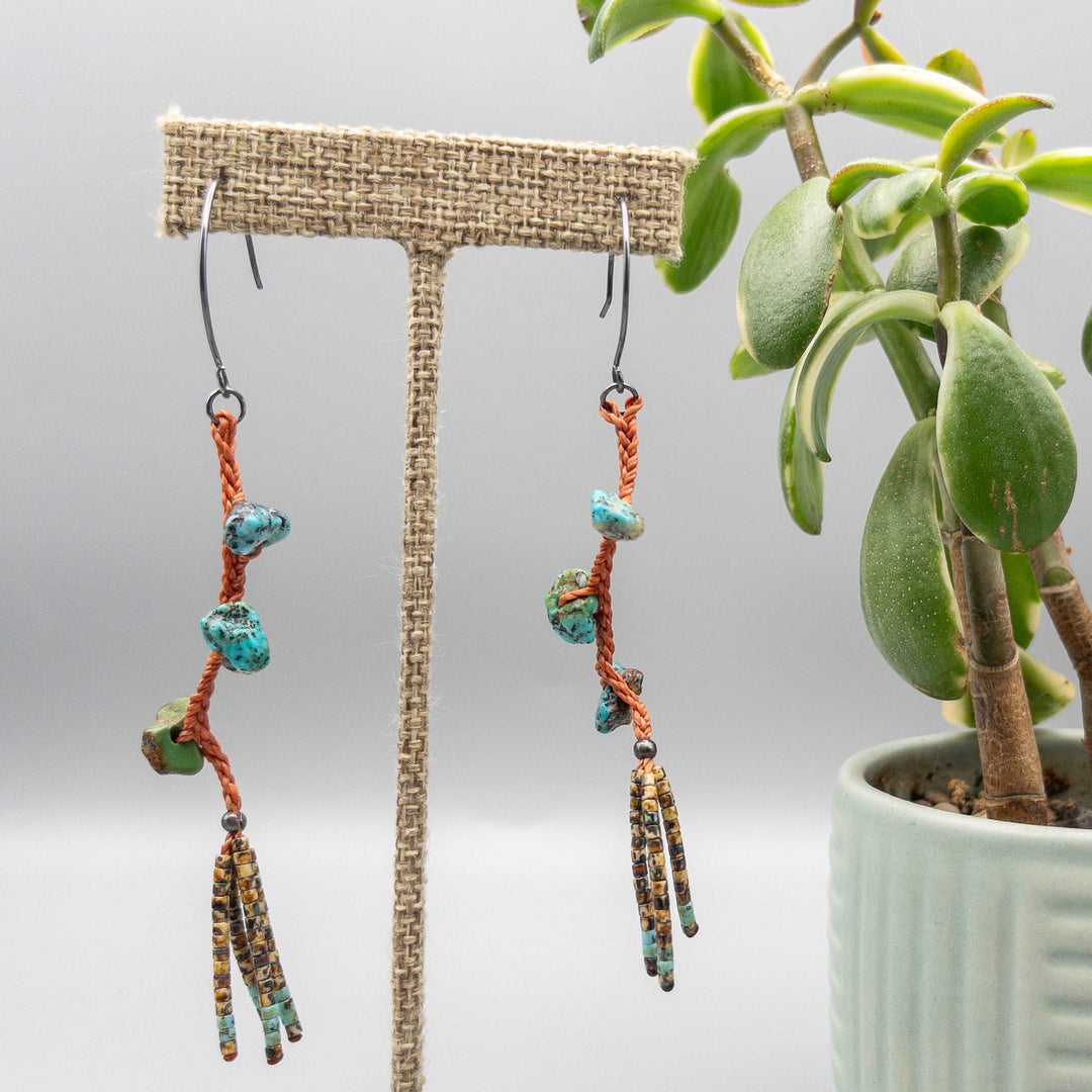 Turquoise dangle earrings with hand-formed oxidized sterling silver ear wires and a seed bead fringe front view.
