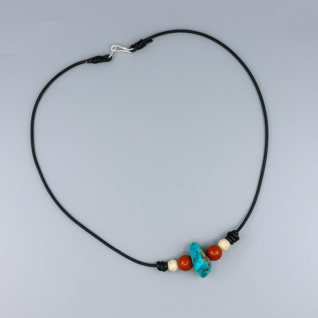 handmade turquoise, red jasper, and riverstone leather choker with sterling silver hook clasp on gray background
