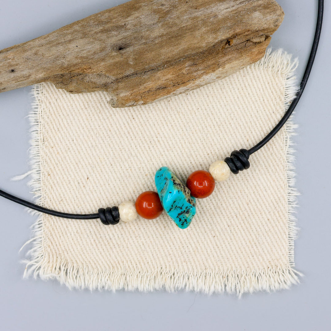 turquoise, red jasper, and riverstone leather choker with sterling silver hook clasp on off white background