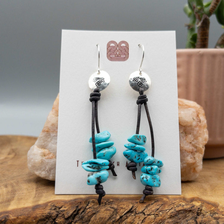 Handmade turquoise bead sterling silver earrings on a white card