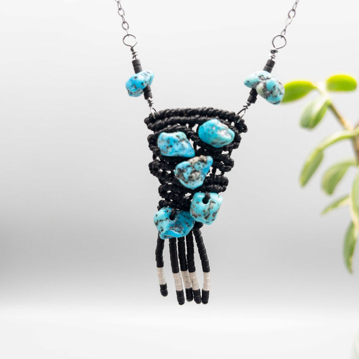 close up of hand-woven macrame necklace with vintage kingman turquoise beads black with sterling silver chain