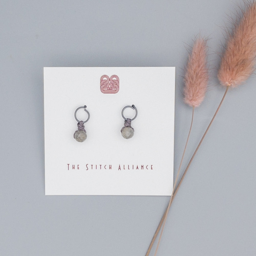 oxidized sterling silver post style earrings with labradorite bead on a gray background