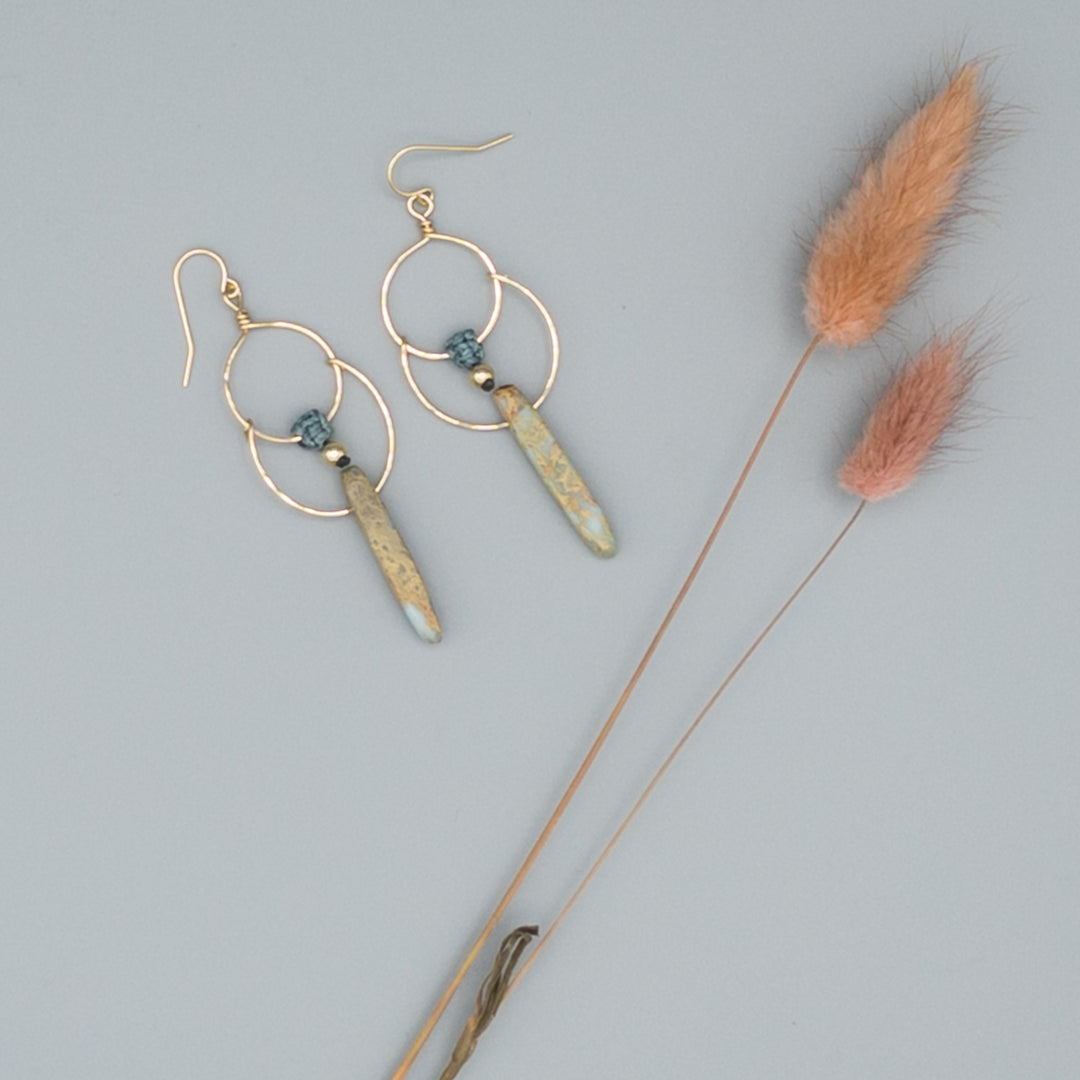 14k gold filled double hoop earrings with an aqua terra jasper bead on a gray background