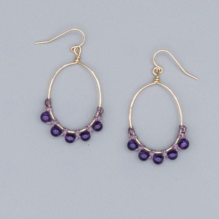 close up of amethyst hoop earrings 14k gold fill oval shape