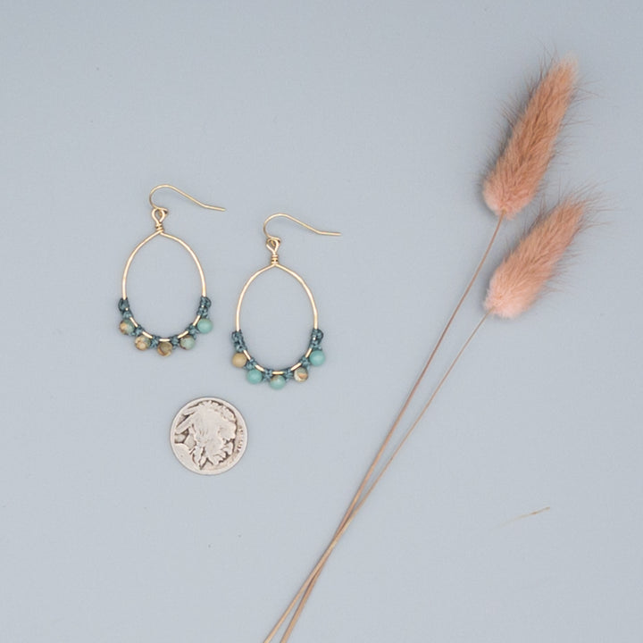 boho style gold-filled oval hoop earrings with aqua terra jasper beads with a nickle for size comparison