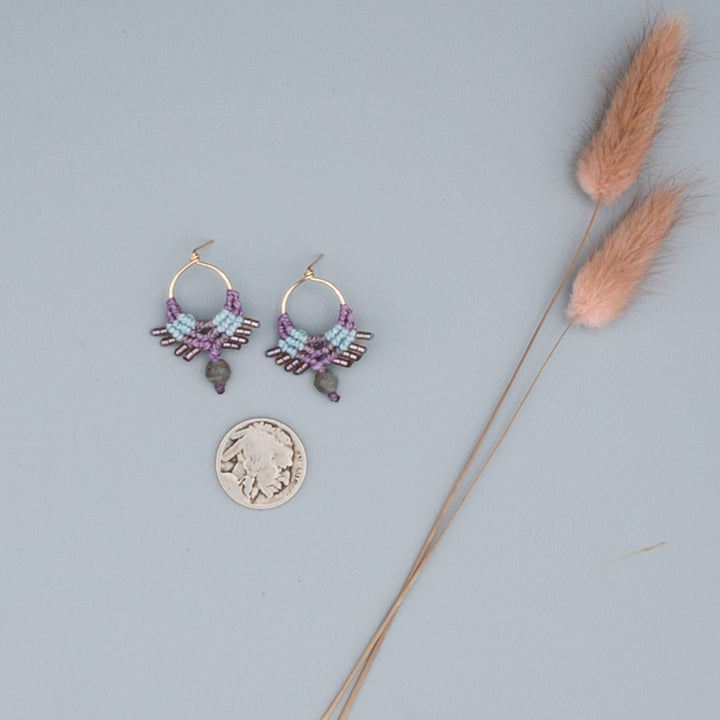 14k gold filled post-style macrame earrings in beach-inspired colors with labradorite beads on a gray background with a buffalo nickel for size comparison