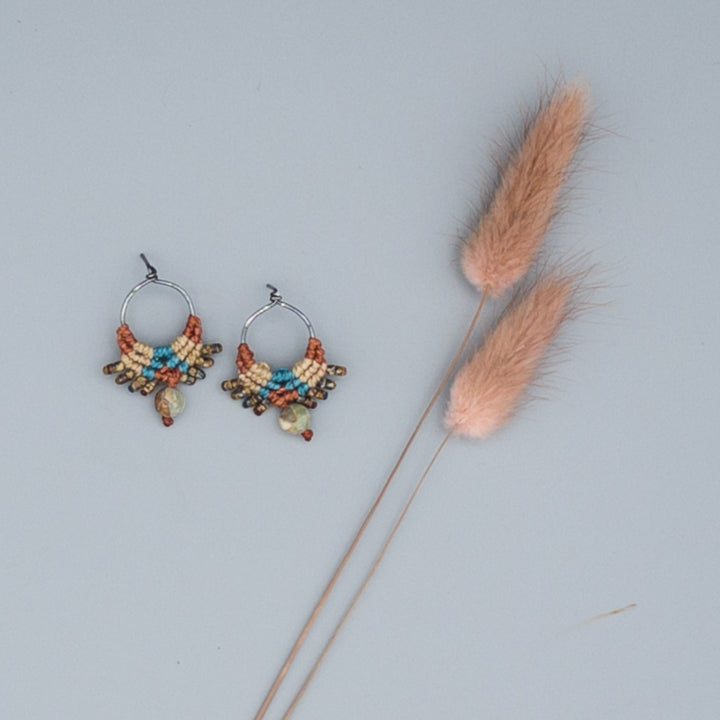 oxidized sterling silver macrame post style earrings. Sedona-inpired colors with aqua terra jasper beads shown on a gray background