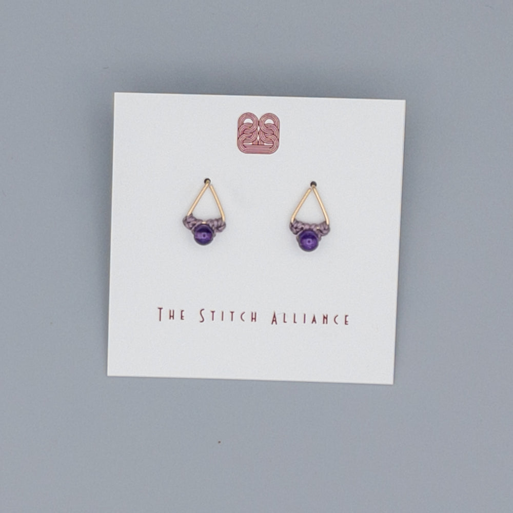 close up of 14k gold filled triangle post earrings with amethyst beads
